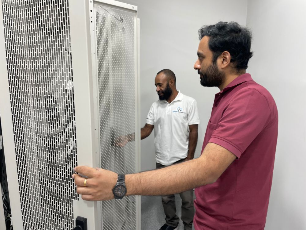 Sprint Networks engineers installing a network rack